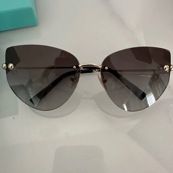Tiffany & Co. 
Brand new pair
Dark gray with gold details LVMH Watch Week 2025: Tiffany & Co. Debuts New Jewelry  main image 4